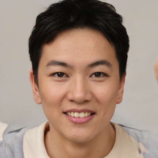 Joyful asian young-adult female with short  brown hair and brown eyes