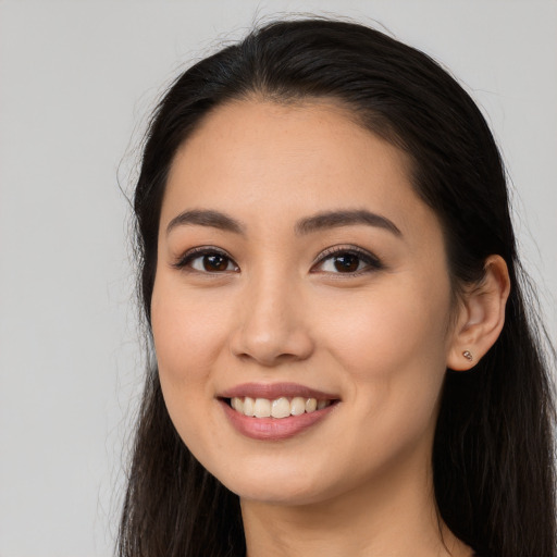 Joyful white young-adult female with long  black hair and brown eyes