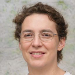 Joyful white adult female with medium  brown hair and green eyes