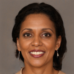 Joyful black adult female with medium  brown hair and brown eyes