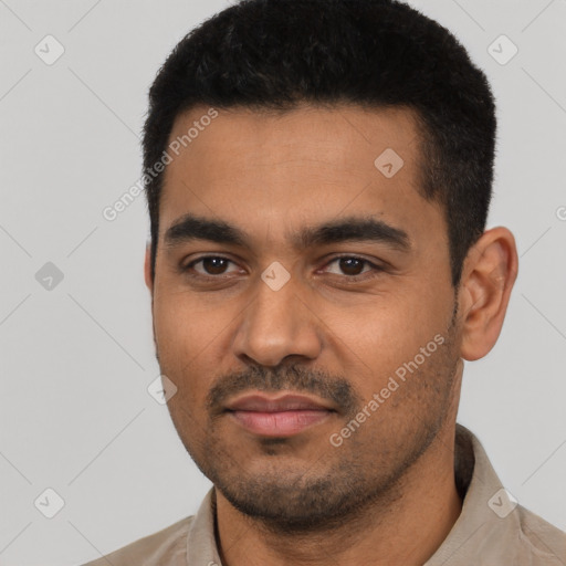 Joyful latino young-adult male with short  black hair and brown eyes