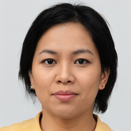 Joyful asian young-adult female with medium  black hair and brown eyes