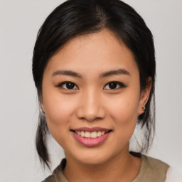 Joyful asian young-adult female with medium  black hair and brown eyes