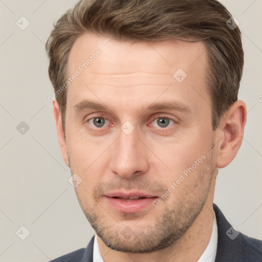 Joyful white adult male with short  brown hair and grey eyes