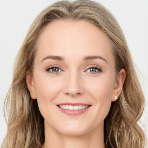 Joyful white young-adult female with long  brown hair and blue eyes