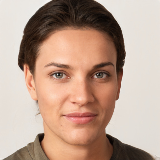 Joyful white young-adult female with short  brown hair and grey eyes