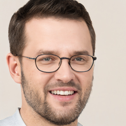 Joyful white young-adult male with short  brown hair and grey eyes