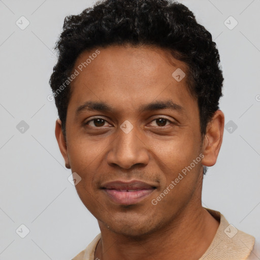 Joyful black young-adult male with short  black hair and brown eyes