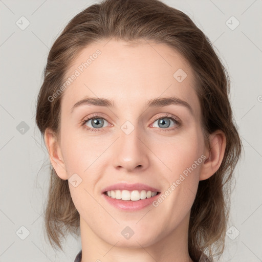 Joyful white young-adult female with medium  brown hair and grey eyes