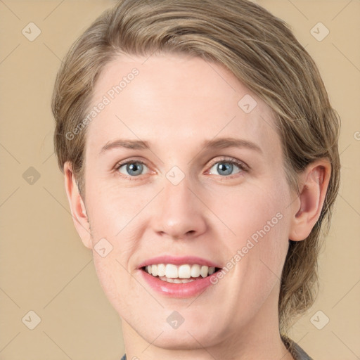 Joyful white young-adult female with medium  brown hair and grey eyes