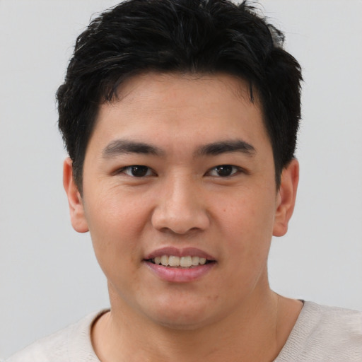 Joyful asian young-adult male with short  brown hair and brown eyes