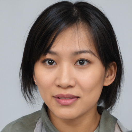 Joyful asian young-adult female with medium  brown hair and brown eyes