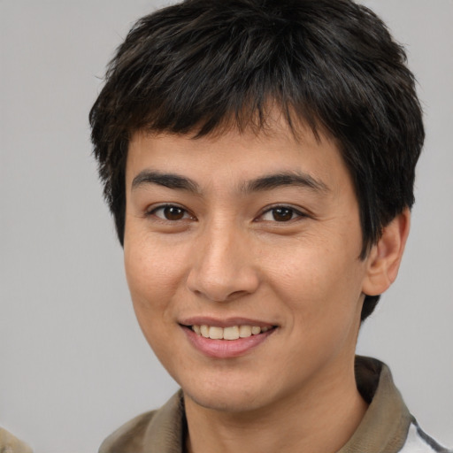 Joyful asian young-adult male with short  brown hair and brown eyes