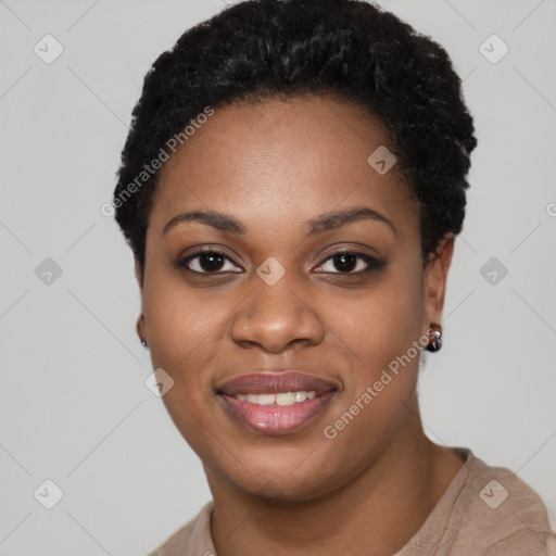 Joyful black young-adult female with short  black hair and brown eyes