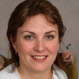 Joyful white young-adult female with medium  brown hair and blue eyes