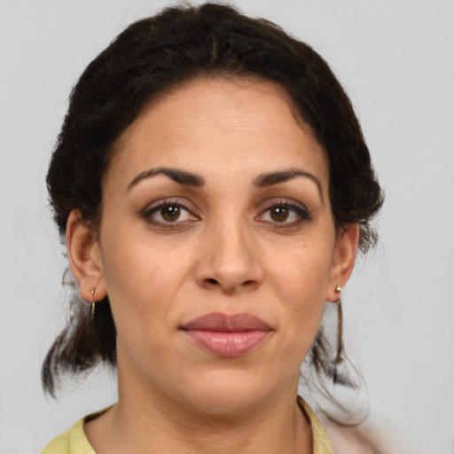 Joyful white adult female with medium  brown hair and brown eyes