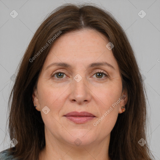 Joyful white adult female with long  brown hair and brown eyes