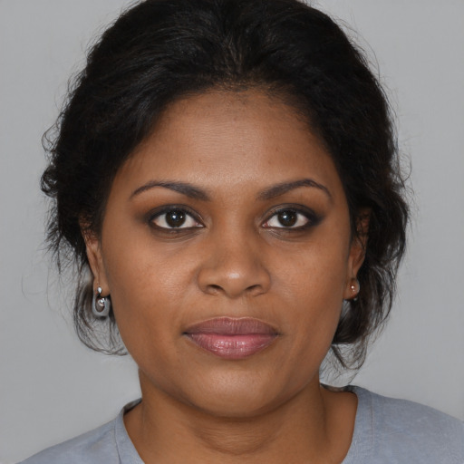 Joyful black young-adult female with medium  brown hair and brown eyes