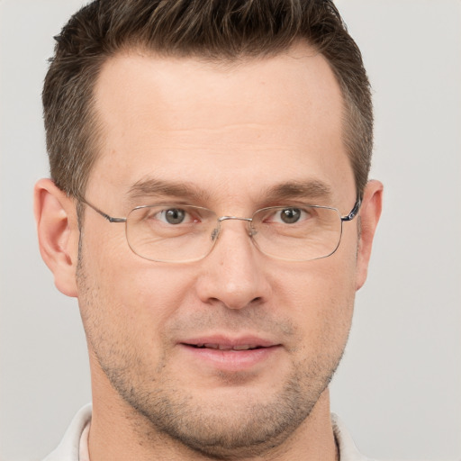 Joyful white adult male with short  brown hair and brown eyes