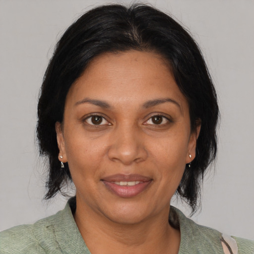 Joyful black adult female with medium  black hair and brown eyes