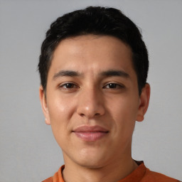 Joyful latino young-adult male with short  black hair and brown eyes