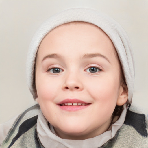 Joyful white child female with short  brown hair and blue eyes