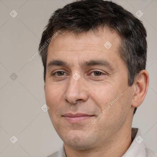 Joyful white adult male with short  brown hair and brown eyes