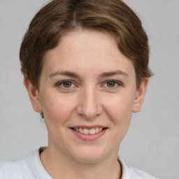 Joyful white young-adult female with short  brown hair and grey eyes