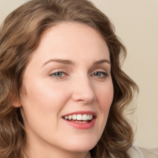 Joyful white young-adult female with medium  brown hair and green eyes