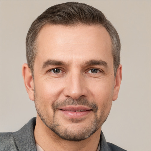 Joyful white adult male with short  brown hair and brown eyes