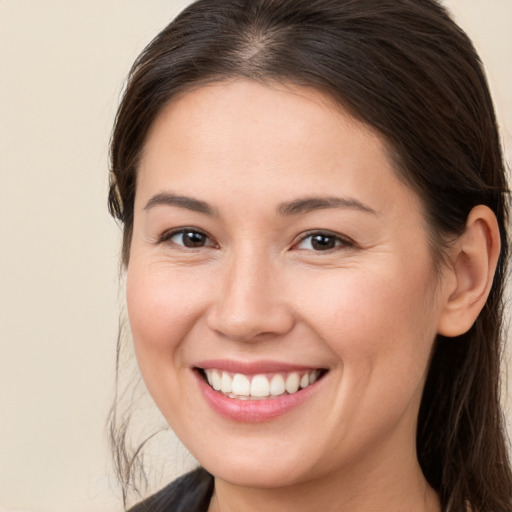 Joyful white young-adult female with long  brown hair and brown eyes