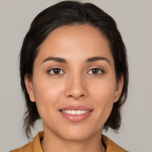 Joyful white young-adult female with medium  brown hair and brown eyes