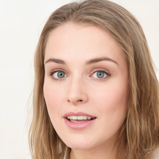 Joyful white young-adult female with long  brown hair and blue eyes