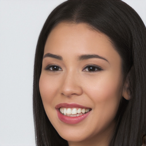 Joyful latino young-adult female with long  brown hair and brown eyes