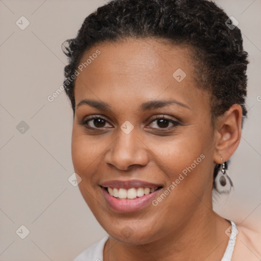 Joyful black young-adult female with short  brown hair and brown eyes