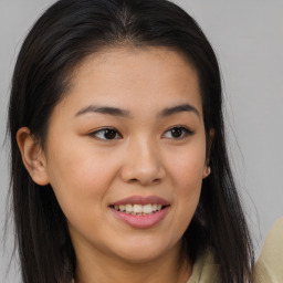 Joyful asian young-adult female with long  brown hair and brown eyes