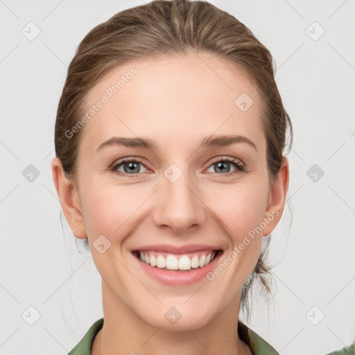 Joyful white young-adult female with medium  brown hair and green eyes