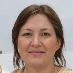 Joyful white adult female with medium  brown hair and brown eyes