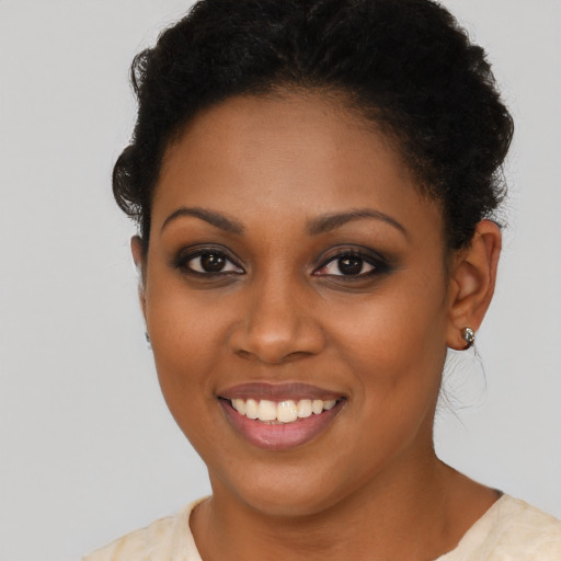 Joyful black young-adult female with short  brown hair and brown eyes