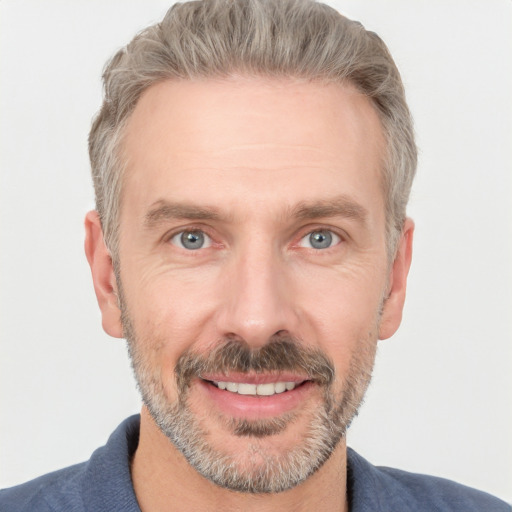 Joyful white adult male with short  brown hair and grey eyes