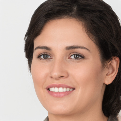 Joyful white young-adult female with medium  brown hair and brown eyes