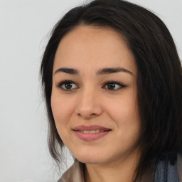 Joyful asian young-adult female with long  brown hair and brown eyes