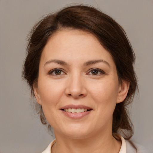 Joyful white adult female with medium  brown hair and brown eyes