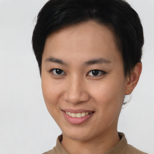 Joyful asian young-adult female with short  black hair and brown eyes