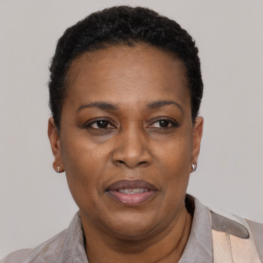 Joyful black adult female with short  black hair and brown eyes