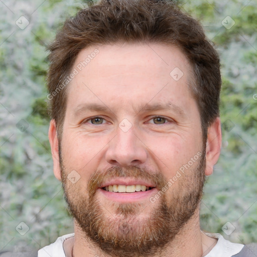 Joyful white adult male with short  brown hair and brown eyes