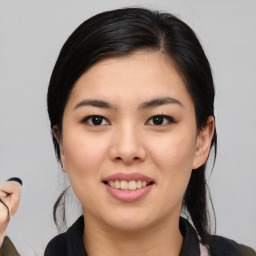 Joyful asian young-adult female with medium  black hair and brown eyes