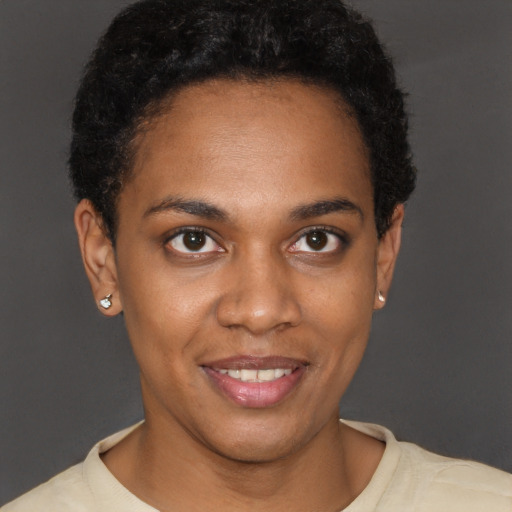 Joyful black young-adult female with short  brown hair and brown eyes