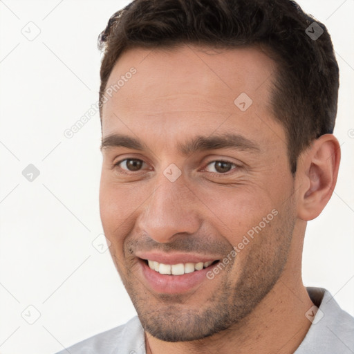 Joyful white young-adult male with short  brown hair and brown eyes