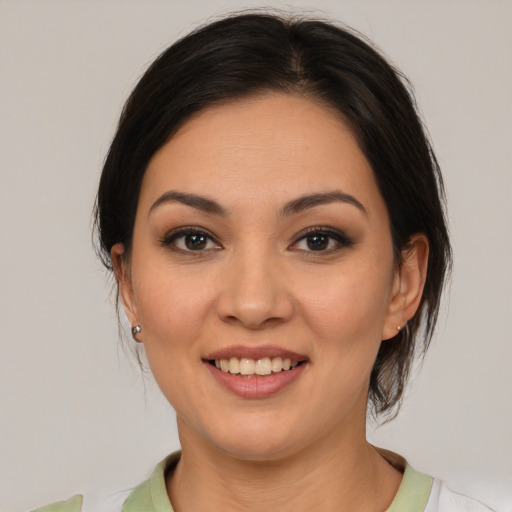 Joyful latino young-adult female with medium  brown hair and brown eyes